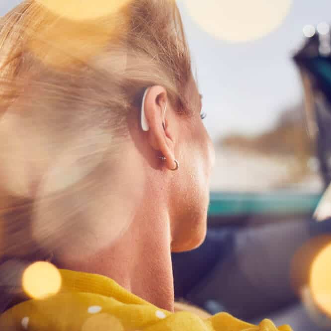 Woman in Car with Hearing Aids In