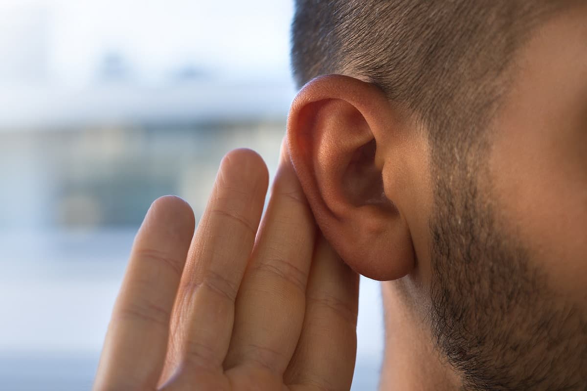 man holding ear